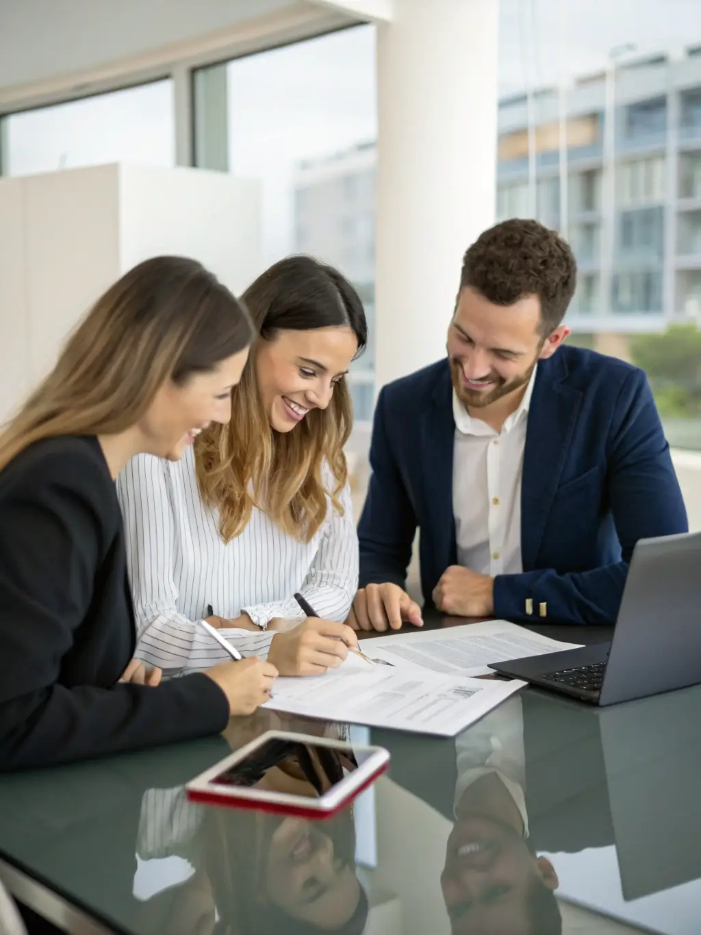A happy couple shaking hands with a real estate agent in a modern office, symbolizing the successful purchase of a property through Zebra Inversion.